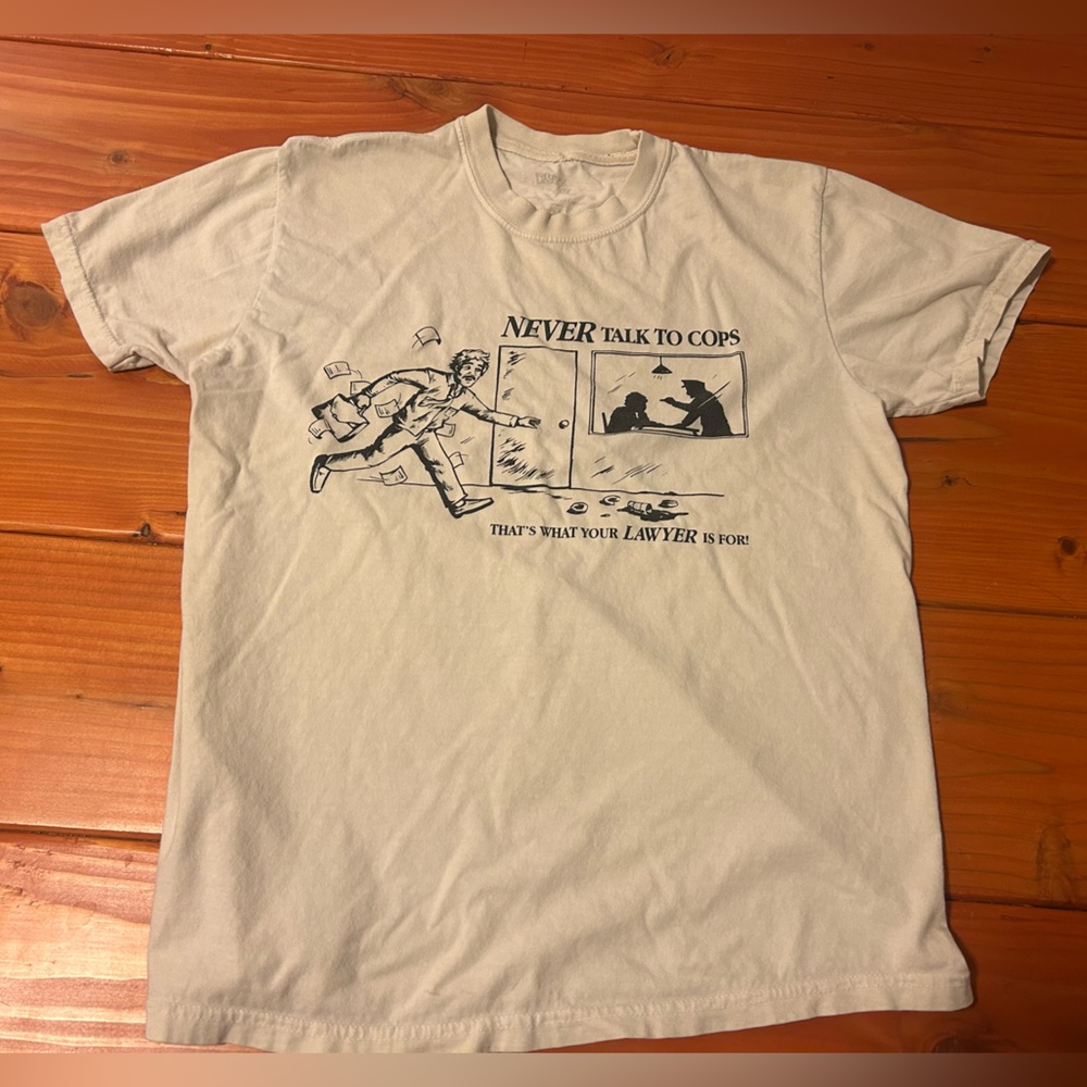 Cream graphic tee “never talk to the cops” design